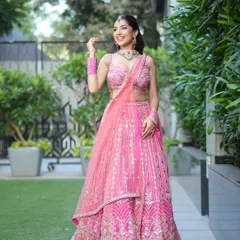 A full-length view of this stunning pink lehenga, perfect for an outdoor event. The drape is light and airy, matching the happy and celebratory mood.
