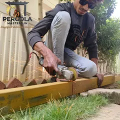 A member of our team carefully grinds a metal beam, ensuring a smooth surface before painting and installation. This attention to detail in the preparation phase is crucial for achieving a flawless and durable final product.