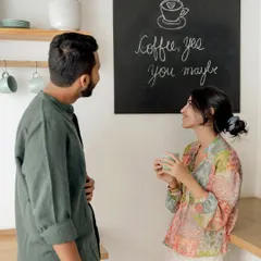 "Coffee, yes. You, maybe." A playful moment in a bright, modern kitchen setting. This lifestyle pre-wedding shoot is perfect for telling the story of your daily life together.