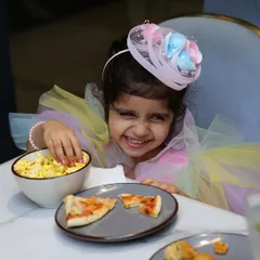 This is what pure birthday joy looks like. Dressed in her unicorn best, this little one is happily digging into some popcorn and pizza at her party. We love seeing these priceless smiles at our cafe.