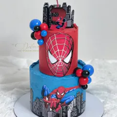 A two-tiered Spiderman cake for a little superhero's birthday. The design features the city skyline, Spiderman's face, and a fun candle placement on top.