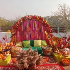 A perfect rooftop Mehandi setup with a vibrant, bohemian vibe. We used a floral arch, colourful tassels, low seating with gaddas, and lots of props for a festive and photogenic event.