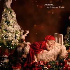 Little Santa's big Christmas dreams. This wider shot shows our complete Christmas scene, with a glowing tree, reindeer, and festive decorations creating a magical holiday atmosphere.