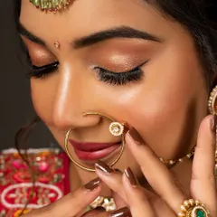 This close-up on a bridal nath (nose ring) and hathphool (hand jewelry) showcases the intricate details and craftsmanship of high-end wedding accessories.