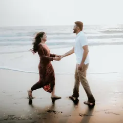 A candid shot of a couple walking hand-in-hand on the beach at sunset. I focus on capturing natural movement and laughter during our pre-wedding sessions.
