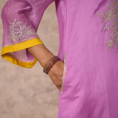 A close-up of a lilac kurta sleeve with delicate silver sequin embroidery, showcasing the fine craftsmanship.
