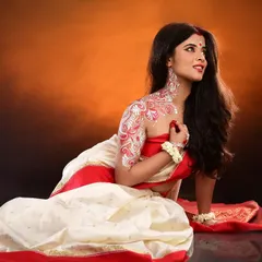 A full-length view of the Bengali look, showing how the Alpona art extends from the neck down the arm, integrating with the traditional red and white saree for a complete festive appearance.