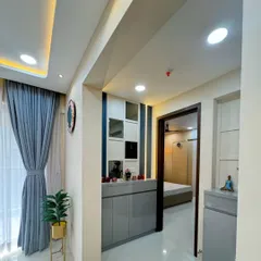 Another view of the entryway, showing the grey storage unit in the context of the hallway. The design is modern and helps create a welcoming first impression.