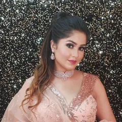 A model in a peach sequined saree, wearing a delicate rose gold diamond choker. This is a great look for a modern, chic portfolio.