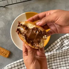 A cross-section of my Nutella-filled brioche doughnut. The soft, fluffy dough gives way to a generous, creamy Nutella center. It's a simple and perfect indulgence.