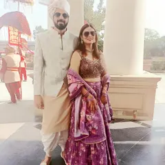 Here’s a great example of coordinating for a daytime event. The groom’s subtle patterned bandhgala and the bride’s floral print purple lehenga create a fresh, modern, and stylish couple look.