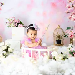 Waving her magic wand amidst a sea of clouds and blossoms. This fairy-themed photoshoot is perfect for capturing the wonder of childhood.