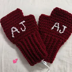 A pair of personalized fingerless gloves in a rich maroon color, with the initials 'AJ' stitched in white. This is a perfect example of the custom work I love to do.