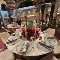 For Jeet Adani and Diva Shah’s Sangeet, we designed a sit down dinner that was both grand and intimate. The tablescape, with its deep red florals and warm candlelight, set the stage for an evening of refined taste and celebration.