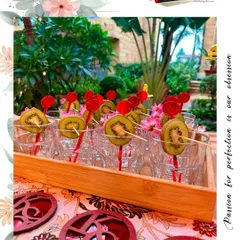 Custom-designed glass markers and kiwi garnishes add a touch of elegance and personalization to every drink we serve.