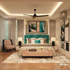 A bedroom that perfectly balances color and calm. The teal headboard provides a beautiful focal point, complemented by soft pink and neutral tones in the bedding and accent chair for a chic, modern look.