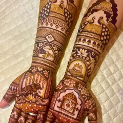 I love creating these grand, royal-themed designs. This Rajwada style mehndi features majestic elephants, proud peacocks, and a doli scene, all brought together with intricate patterns. It’s a statement piece for the bride who wants to feel like a queen.