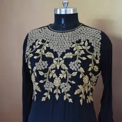 A close-up of intricate gold threadwork on a classic black base. This level of detail is perfect for designer suits meant for family functions or important office events.