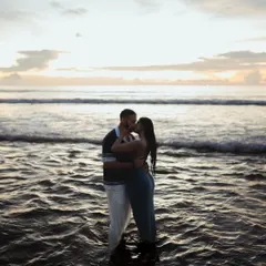 An intimate kiss in the gentle waves of the Phuket sea at dusk. This photo is all about the couple being in their own world, with the ocean as their witness.