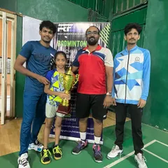 Our student Ananya with her coaches after her tournament win. We are proud to guide our players on their journey.