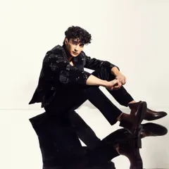 Another angle from the mirrored shoot, showcasing the clean skin finish and well-groomed hair.