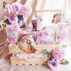 This anniversary hamper is all about celebrating memories. It's filled with photos of the couple, romantic quotes, and a beautiful moon-shaped decorative piece, all in a lovely lavender theme.