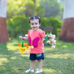 Spreading her wings with a beautiful smile. This candid shot in a sunny park captures the pure happiness and carefree spirit of childhood that I strive to preserve in my photos.
