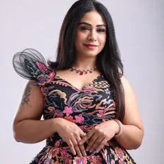 A beautiful portrait featuring a unique floral-patterned gown with a structured shoulder detail, perfect for a fashion-forward look.