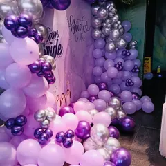 A closer look at the cascading balloon arrangement for the bridal shower. I love mixing different shades and sizes of balloons, like these lilac, purple, and chrome ones, to create depth and a sense of abundance.