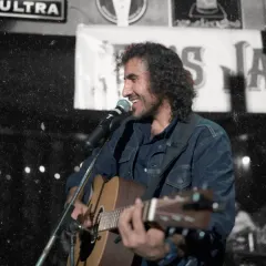 A smiling shot of Jas enjoying the jam session. It's not just a performance for us, we have just as much fun as the audience.