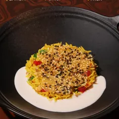 An annotated image of our Chawal ka Zarda, highlighting its key components: the sweet rice, the crunchy sesame crisp, and the creamy almond milk.