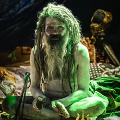 The atmosphere inside the sadhus' tents was otherworldly. I used the available light to capture the moody, intense feeling of the space. This man, covered in sacred ash with his trishul, sat with a quiet power that was palpable.