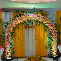 The Haldi stage illuminated with spotlights, making the colors pop and creating a festive ambiance.