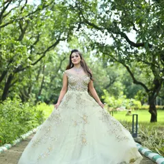 An elegant, flowing gown in a soft pastel green, detailed with delicate silver and gold embroidery. This is a perfect choice for a modern reception or engagement ceremony, offering a blend of tradition and contemporary style.