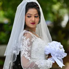 A demure portrait of the bride, her soft makeup and elegant hairstyle perfectly framed by the delicate veil.