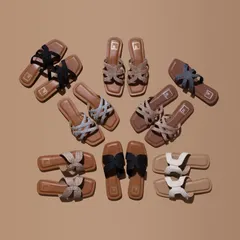 A neat and organized flatlay of a collection of women's sandals. This top down group shot is an excellent way to showcase the variety of styles and colors a brand offers in a single, compelling image.