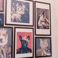 A close-up of our famous gallery wall, featuring portraits of pets dressed as royalty. It's a fun detail that shows how much we adore all animals.