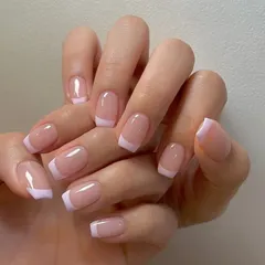 This shows that you don't need extensions for a beautiful French manicure. Here are classic lilac-white tips on short, natural square nails for a clean and chic look.
