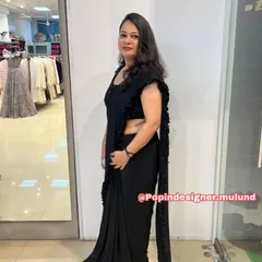 A side view of the black ready-to-wear saree, showing how the ruffles cascade down the edge for a modern and dramatic effect.