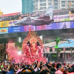 Another perspective of the Lalbaugcha Raja visarjan, with the iconic fighter jet model, capturing the scale and unique elements of the celebration.