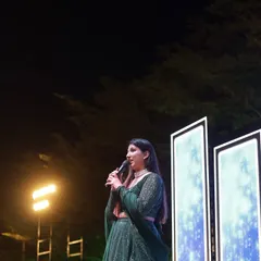 A close-up shot during a Sangeet performance. My focus is on the family, telling their stories and ensuring the evening feels personal and full of love.