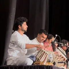 On stage with fellow musicians, providing the live music for a dance concert.