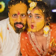 This is what pure, unadulterated fun looks like. I love capturing the real masti of a Haldi ceremony, and this goofy, candid moment shows a couple completely lost in the joy of the ritual, no fake posing needed.