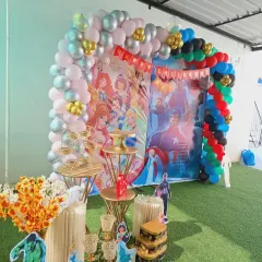 A closer look at the decorative elements, including multi-tiered stands for cakes or snacks and themed floral arrangements, all coordinated with the main backdrop.
