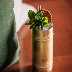 A refreshing summer cocktail served in a classic copper mug. The choice of vessel is crucial for the overall experience, especially for drinks like mules or juleps.