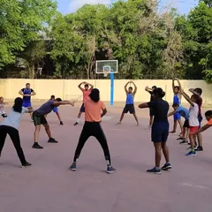 The team performing warm up stretches together before the morning training session begins. Proper warm ups are essential for preventing injuries and preparing the body for a hard workout.
