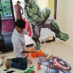 The process of setting up our life-sized superhero cutouts. Here, I'm getting the Hulk ready for action.