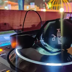 A close-up of my personalized V-MODA headphones on the DJ controller. Having the right professional tools is crucial for monitoring sound and delivering the best possible audio quality.