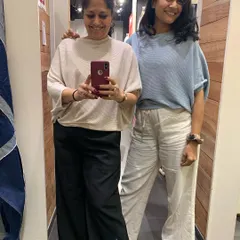 Trying on different tops during a personal shopping session. My goal is to help clients find pieces that not only fit well but also make them feel confident and happy.