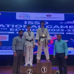 Celebrating a national victory. My student stands at the top of the podium after winning gold at the ISSO National Games. We train for these moments, focusing on the mindset and strategy required for high-level competition.